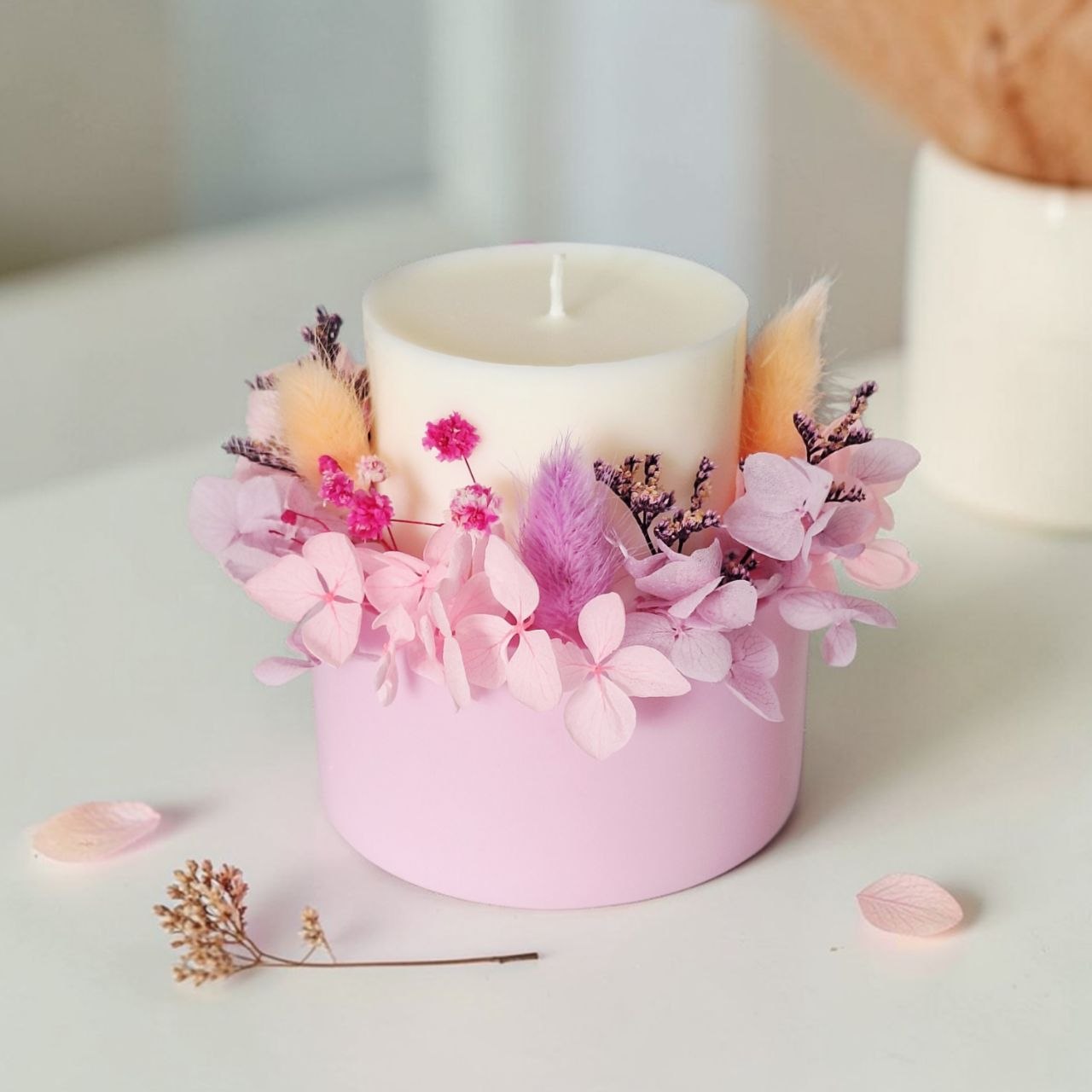 Soft rose botanical soy wax candle with preserved pink flowers and ivory candle top