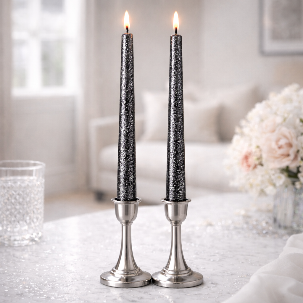 Two black and silver taper candles burning in metallic silver candle holders
