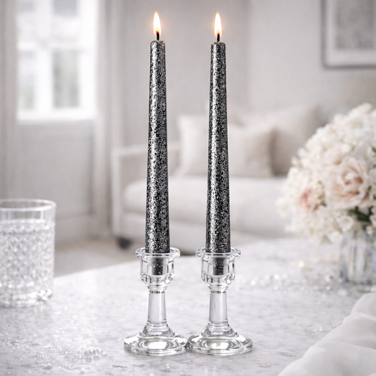 Black and silver soy wax taper candles burning in clear candle holders, handmade in Belgium