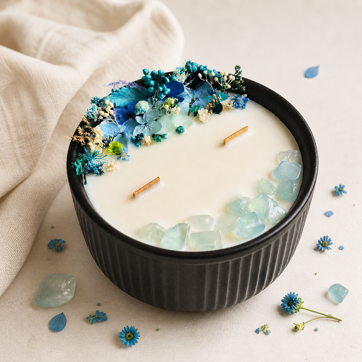 Blue Bloom and Aquamarine floral crystal candle with preserved blue flowers and two wooden wicks, handmade by Isola Candles in Belgium