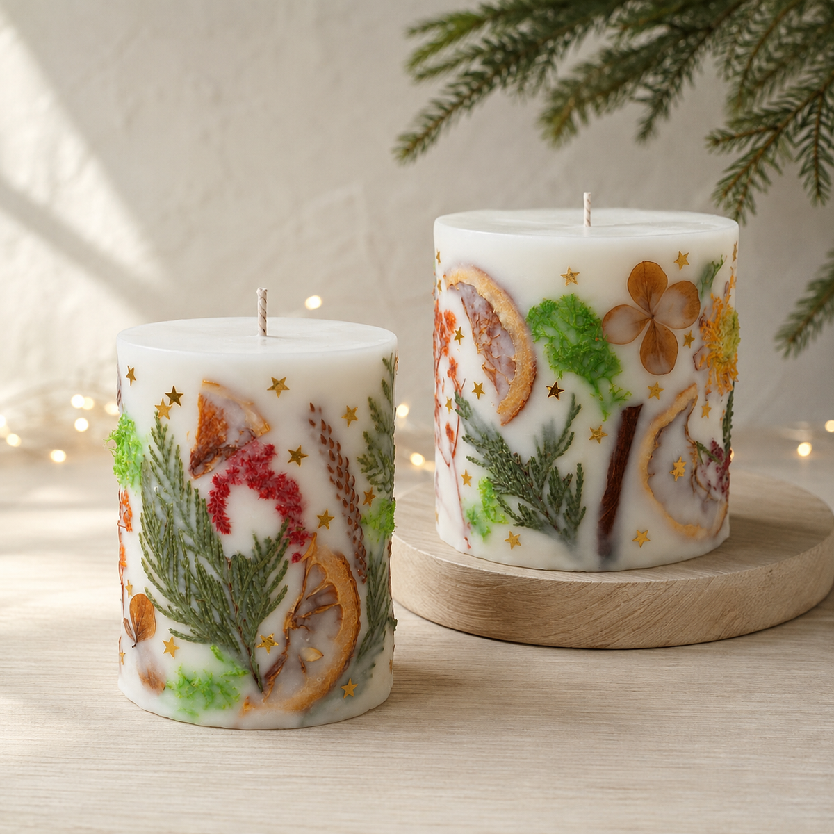 Small and large botanical Christmas candles arranged at different heights on a light wooden stand.