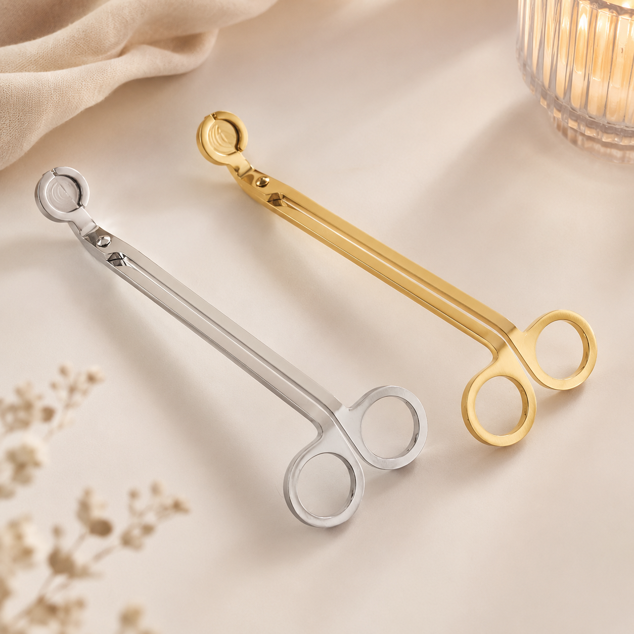 Gold and silver stainless steel candle wick trimmers by Isola Aura Home