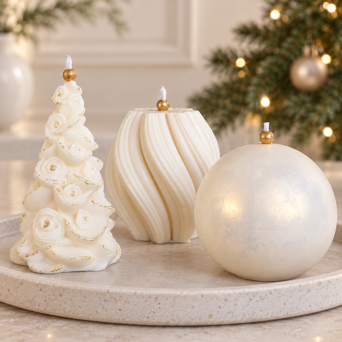 Decorative ivory soy candles with gold details and pearlescent finish displayed beside a Christmas tree