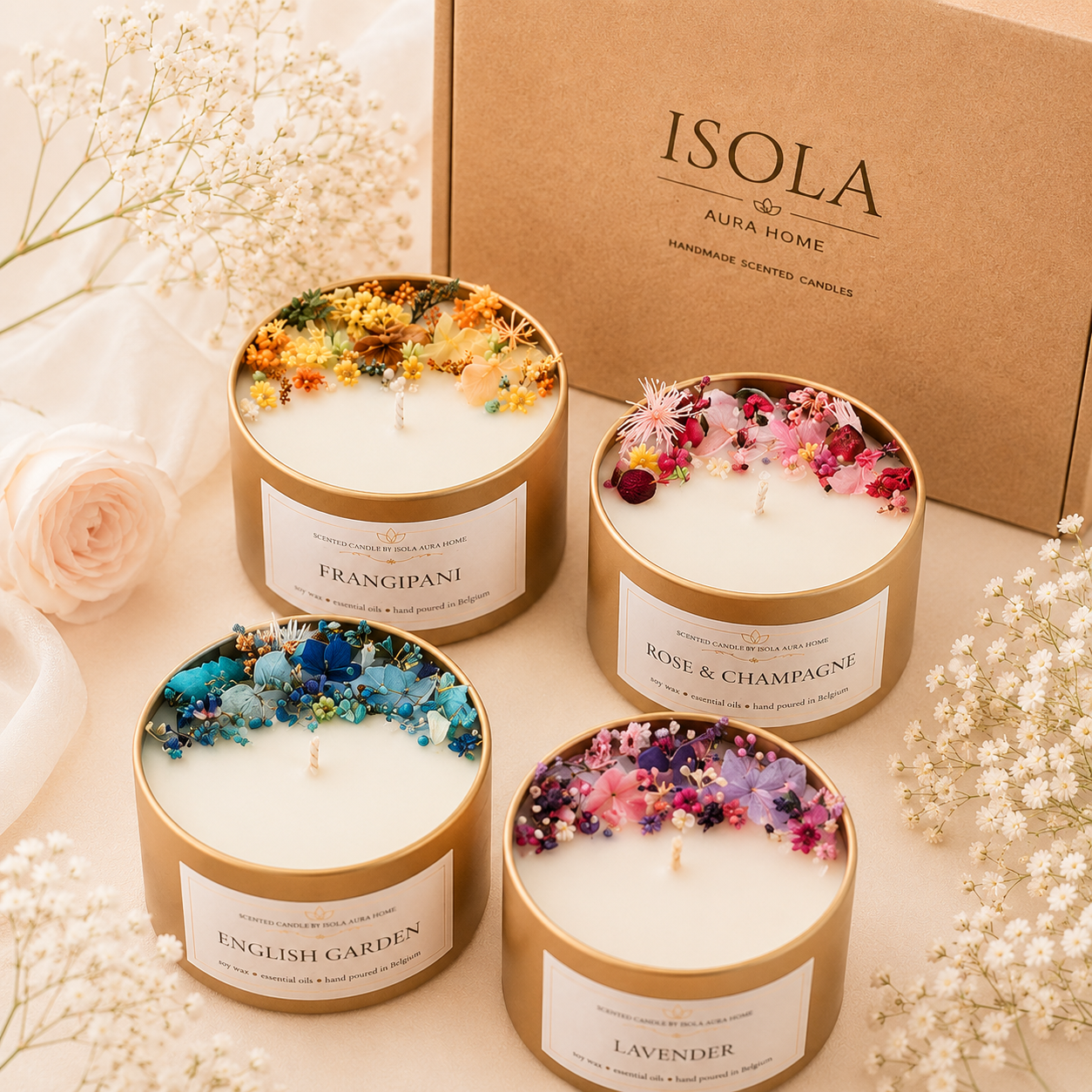 Four designer floral candles with yellow, pink, blue and purple decoration beside an Isola Aura Home box