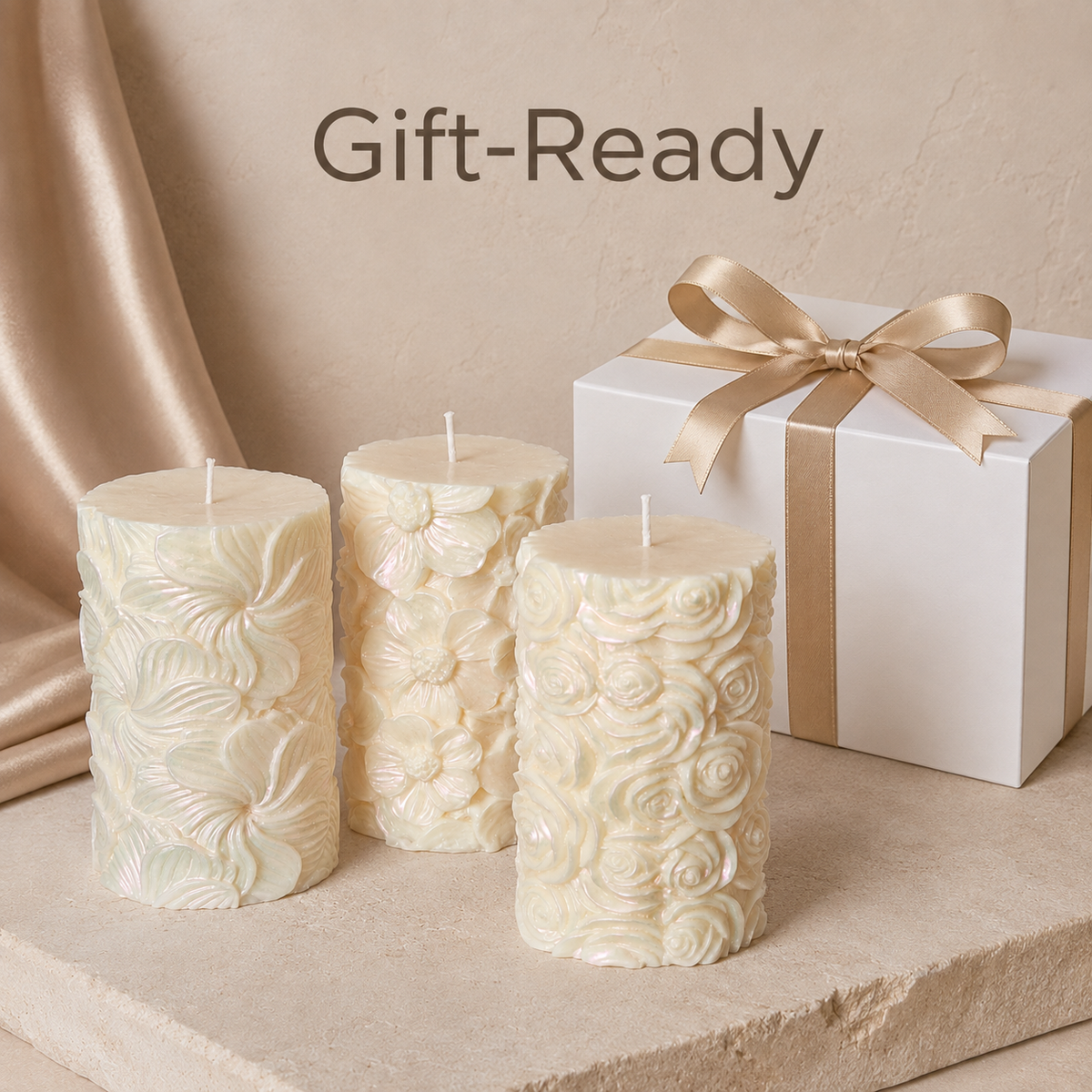 Decorative floral candle with a white gift box and elegant gold ribbon for a gift-ready presentation.