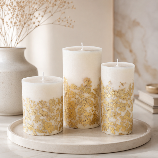Ivory scented soy pillar candles in different sizes with hand-decorated gold leaf details