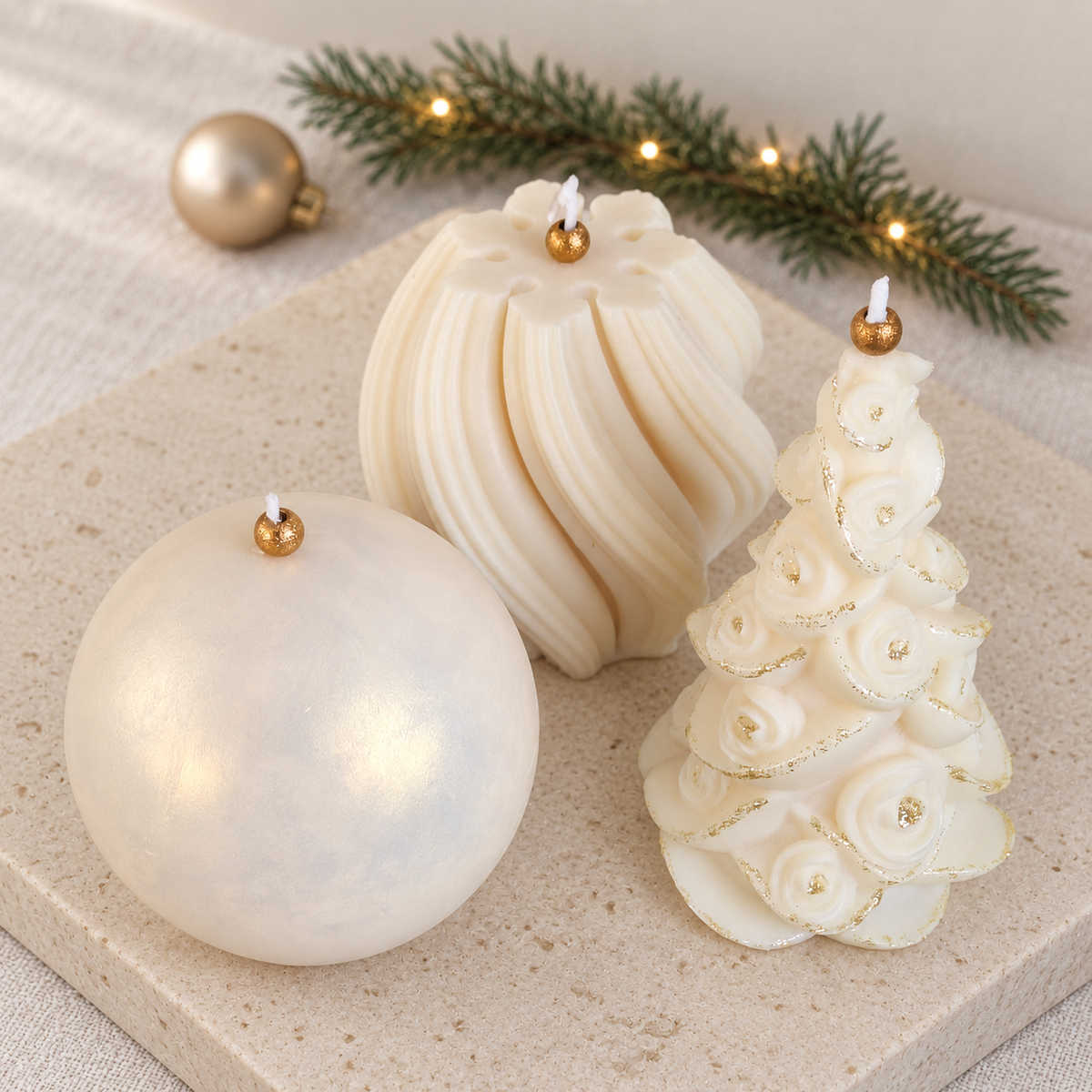 Handmade sculptural Christmas candles with floral, spiral and pearlescent designs in ivory and gold
