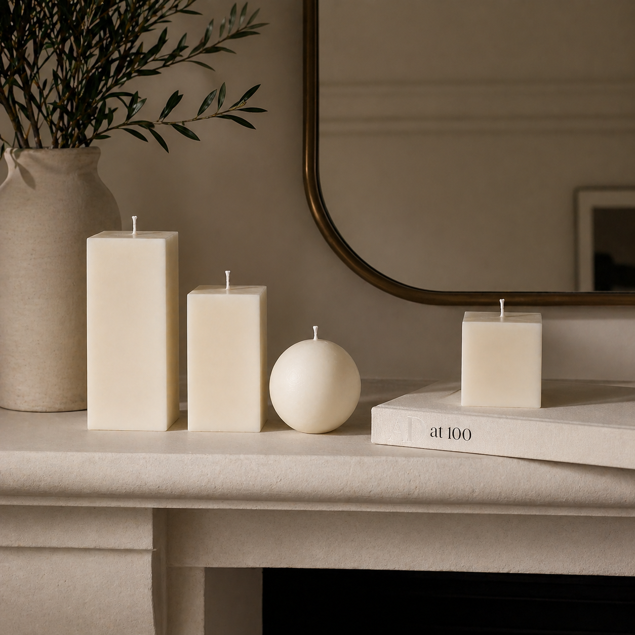 Minimalist geometric candles styled on a mantel, handmade by Isola Aura Home