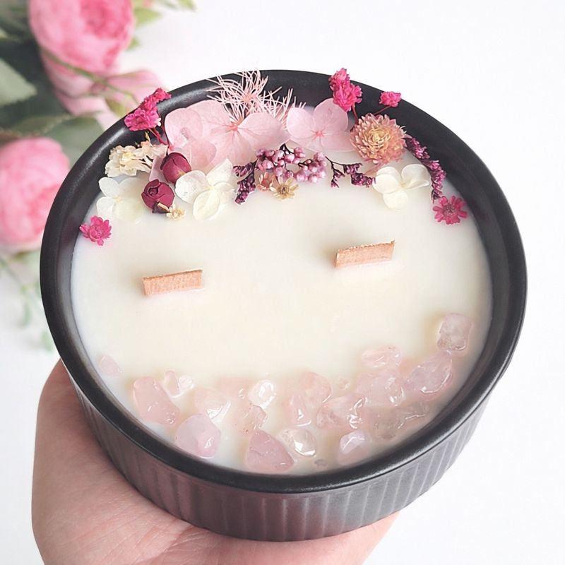 Close-up of Pink Bloom and Rose Quartz floral crystal candle with preserved pink flowers, rose quartz stones and two wooden wicks, handmade by Isola Candles in Belgium