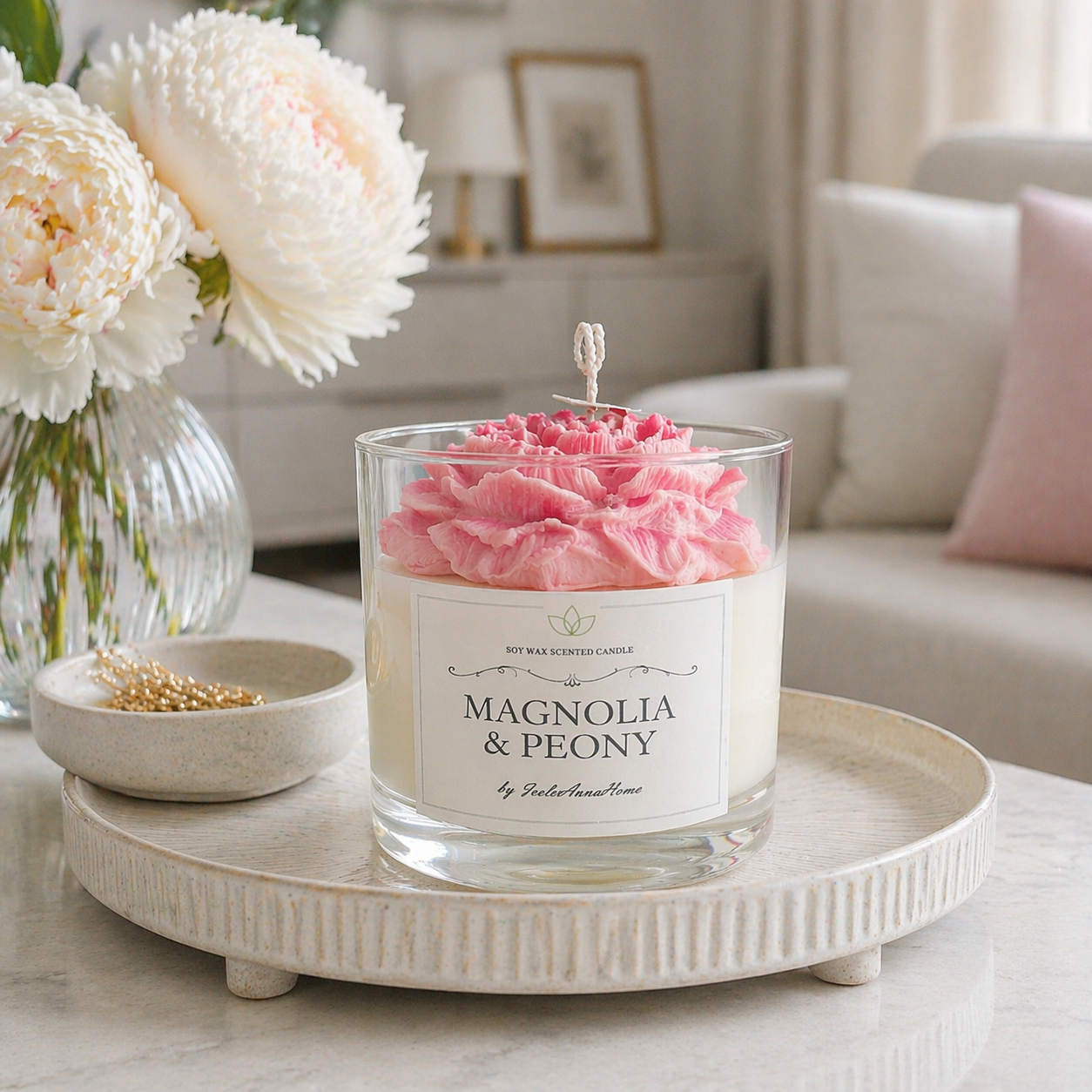 Pink flower-shaped Magnolia and Peony scented soy wax candle in clear glass by Isola Aura Home
