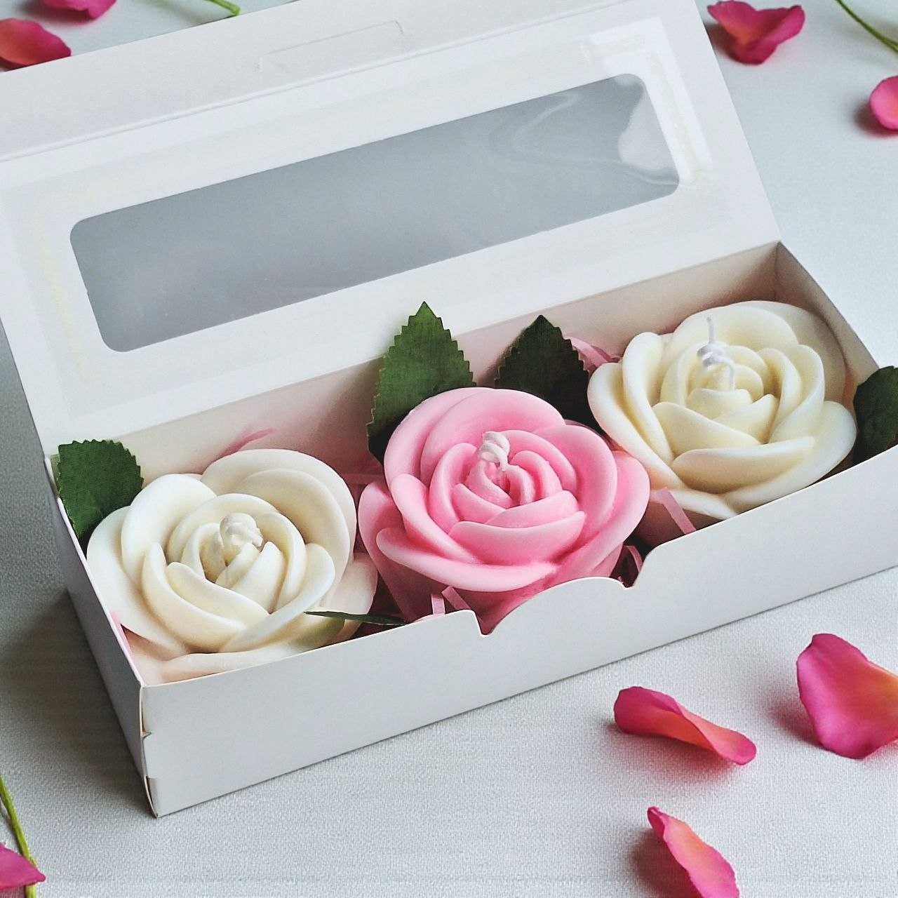 Rose candle gift box with two white candles and one pink candle in a white window box