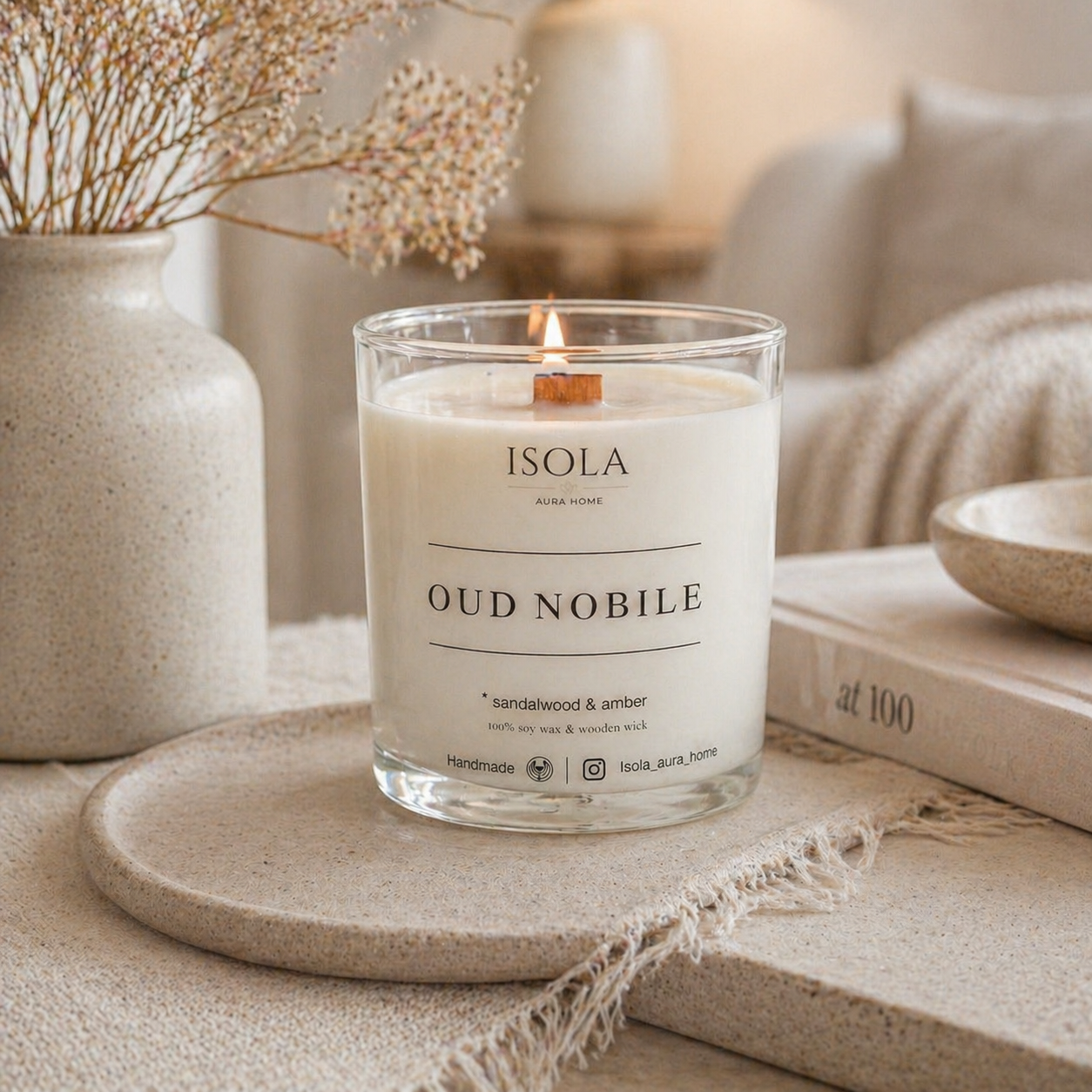 Sandalwood and Amber soy wax candle lit in a cozy home interior, handmade by Isola Aura Home in Belgium