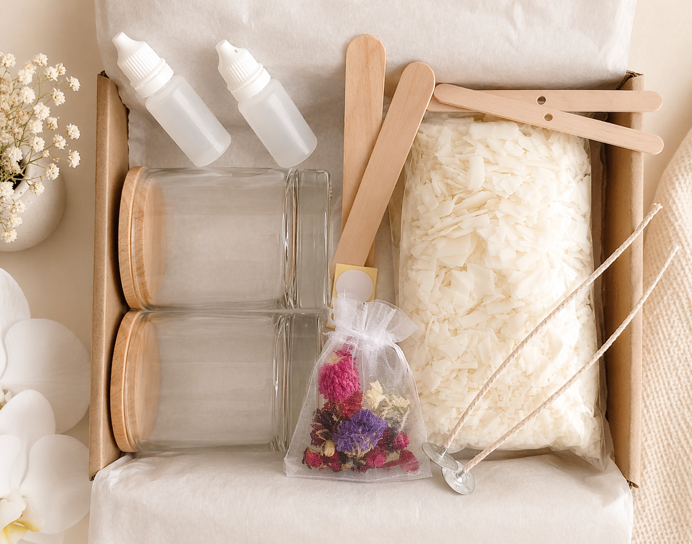 Soy wax candle making kit box contents with two glass jars, wax, wicks, fragrance oils and dried flowers