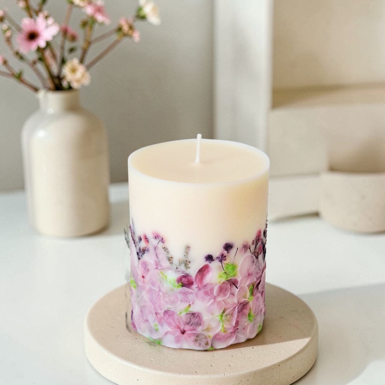 Handmade violet floral soy wax candle with dried flowers in mauve and lavender tones